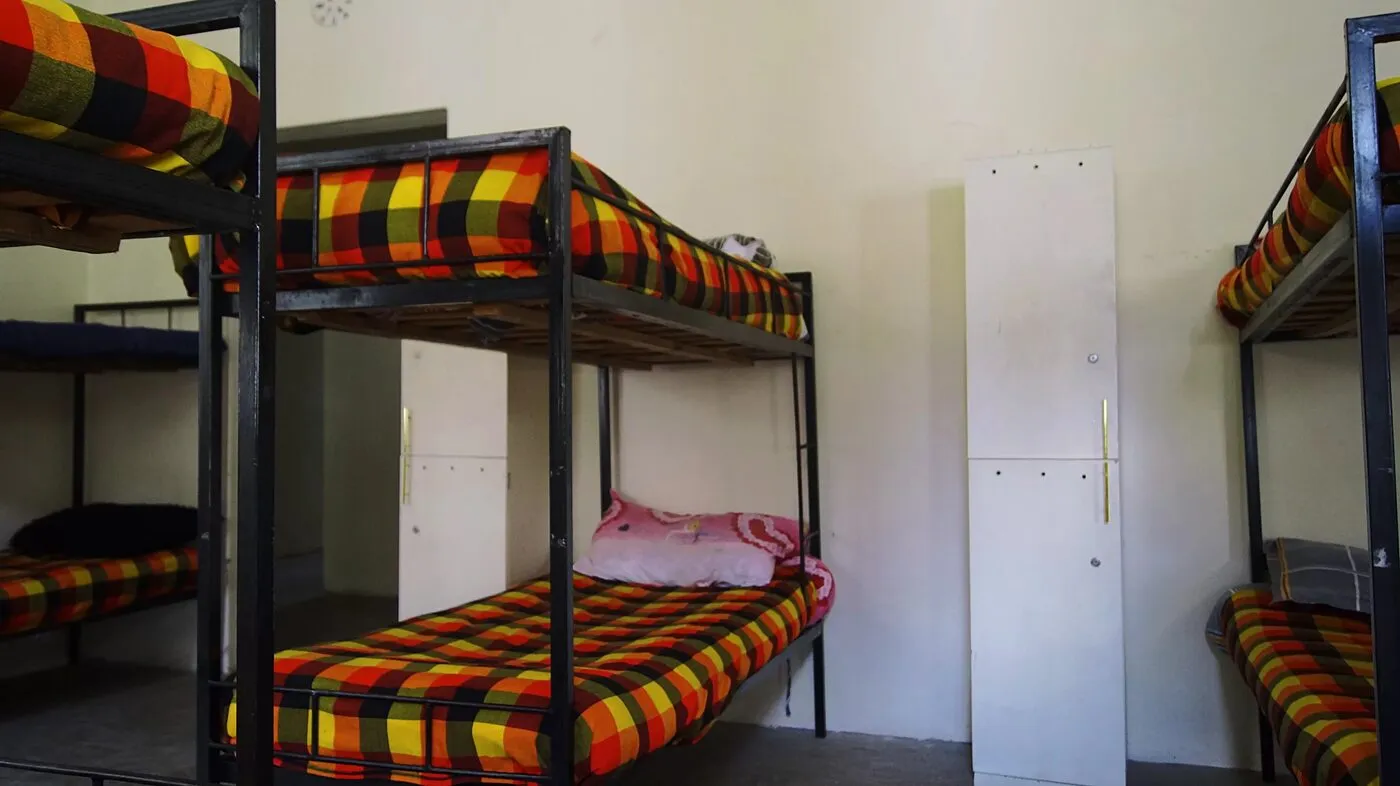 A boarding dormitory with made bunk beds