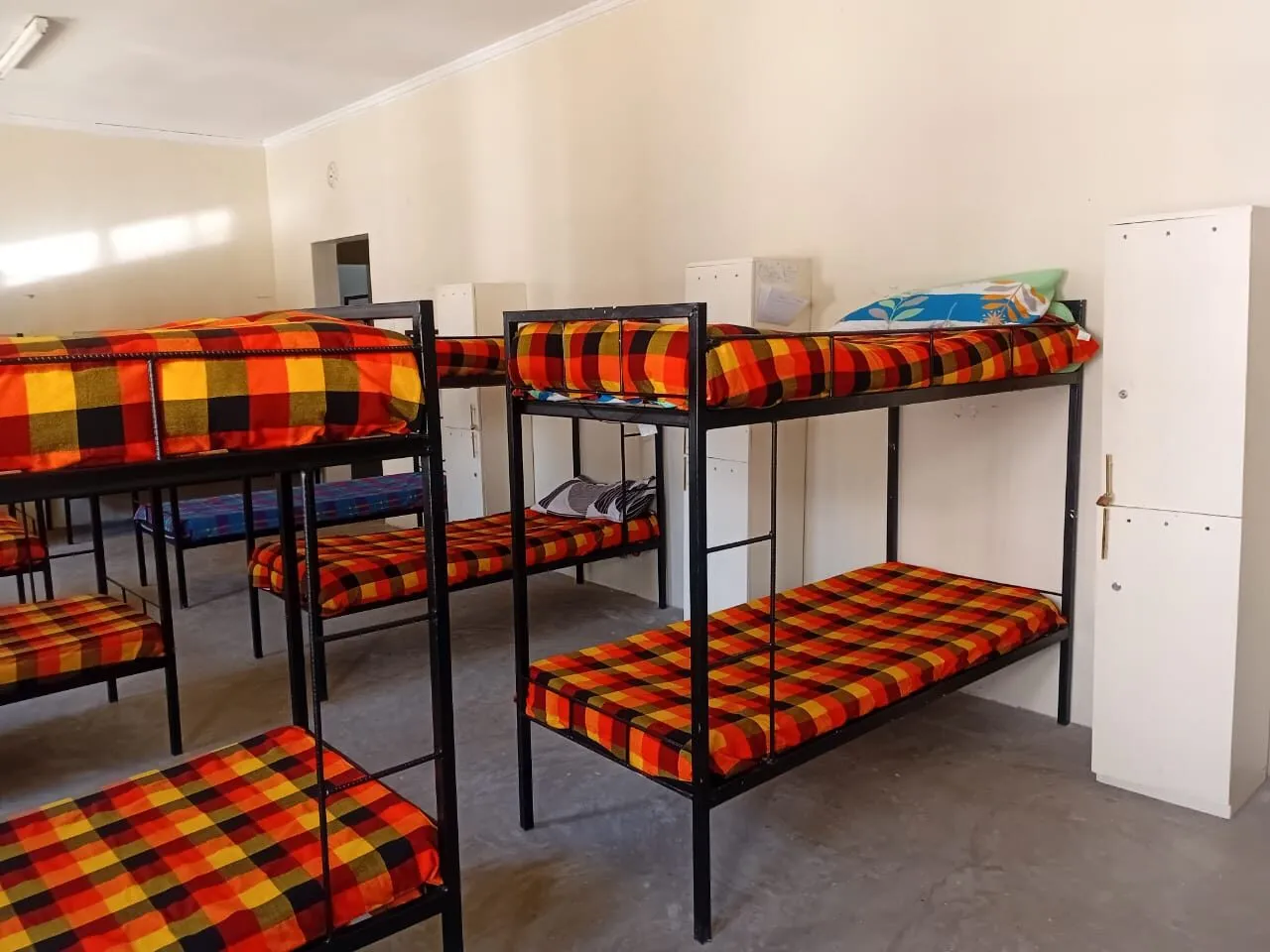 A made bed in a boarding dormitory